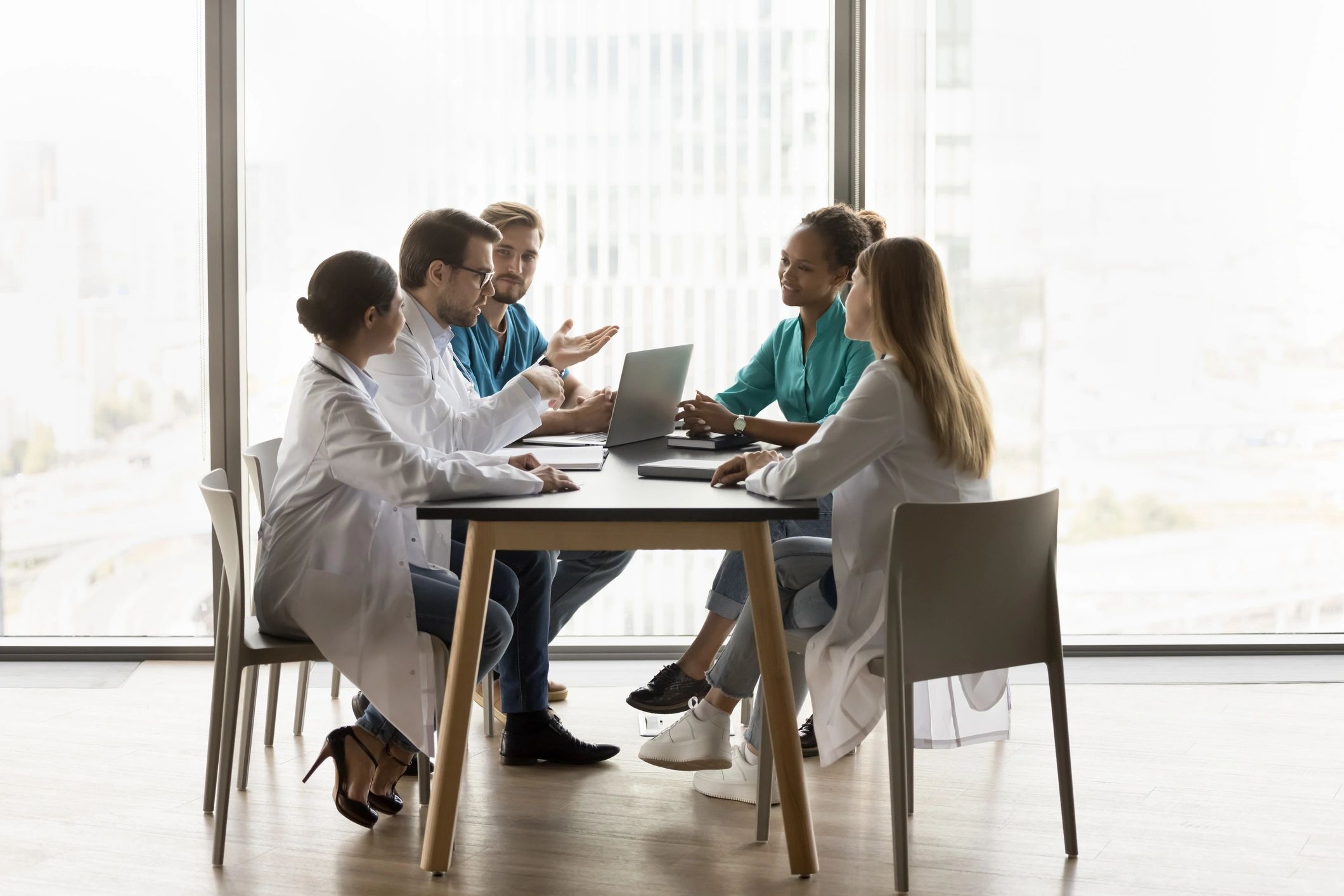 Healthcare professionals discussing cases at a table