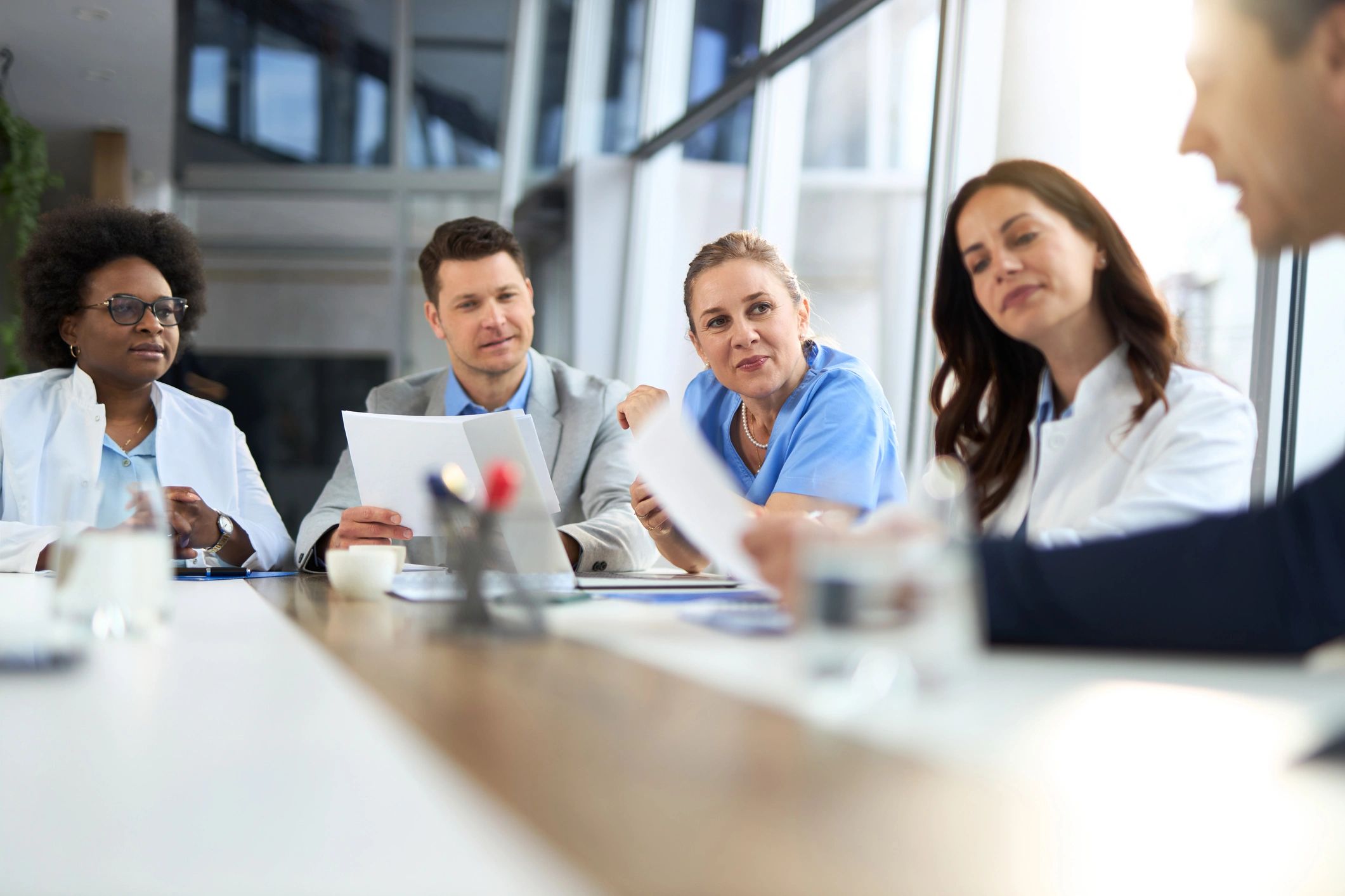 Doctors and business professionals reviewing documents